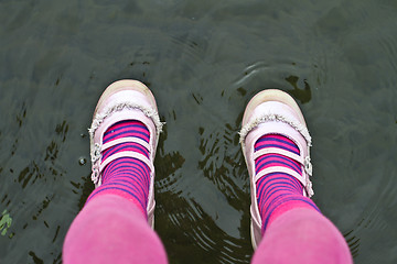 Image showing Pink legs of a child sitting