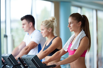 Image showing friends  exercising on a treadmill at the bright modern gym