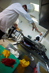 Image showing chef in hotel kitchen prepare food with fire