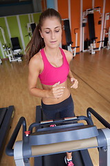 Image showing woman exercising on treadmill in gym