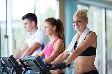 Image showing friends  exercising on a treadmill at the bright modern gym