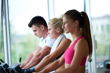 Image showing friends  exercising on a treadmill at the bright modern gym