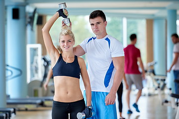 Image showing young sporty woman with trainer exercise weights lifting