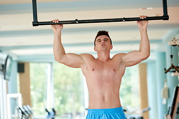 Image showing handsome young mand working out in gym