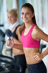 Image showing woman exercising on treadmill in gym