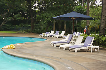Image showing Poolside deck chairs