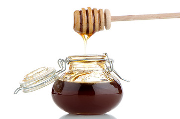 Image showing Jar of honey with wooden drizzler