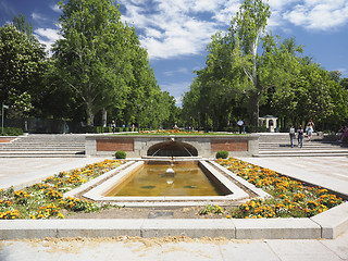 Image showing editorial tourists walk by the fountain entrance to Retiro Park 