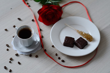 Image showing coffee, two chocolates and a rose