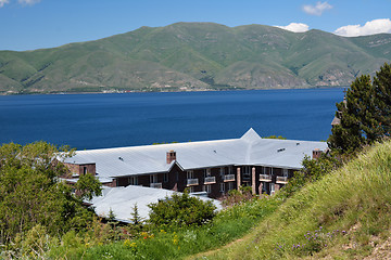 Image showing Sevan lake shore with a house and a hill