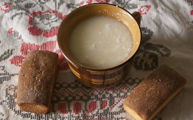 Image showing two soft biscuits with some sour milk 