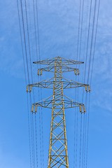 Image showing Large electric pylon with blue sky