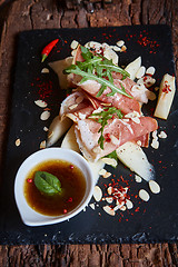 Image showing salad of fresh melon with thin slices prosciutto