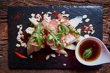 Image showing salad of fresh melon with thin slices prosciutto