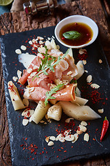 Image showing salad of fresh melon with thin slices prosciutto