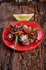 Image showing Baby octopuses in red dish