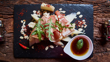 Image showing salad of fresh melon with thin slices prosciutto