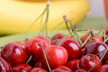 Image showing Close up of a fresh pile of fruit consisting of cherries and bananas