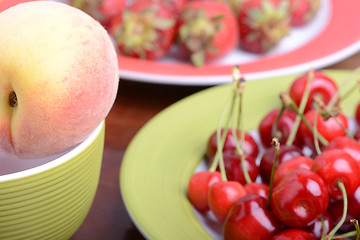 Image showing fresh fruits and berries mixed collection surface close up, summer health food, peach, cherry, strawberry.