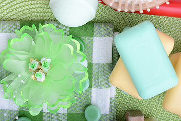 Image showing Spa still life with aromatic candles, sea salt, stones, flower and towel, close up