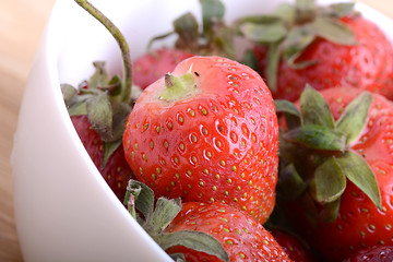 Image showing Closeup of large fresh strawberries in white bowl