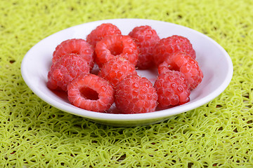 Image showing Fresh raspberries. Closeup of fruits on a white plate