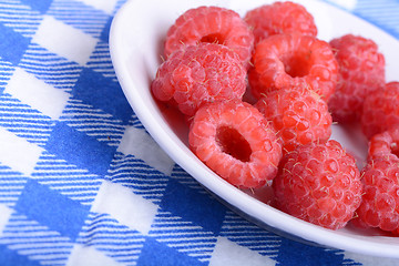 Image showing fresh raspberries on the white plate