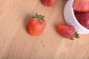Image showing close up of big strawberry on wood