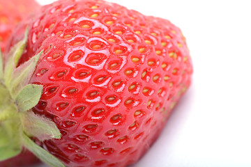 Image showing Close-up detail of a fresh red strawberry with leaves