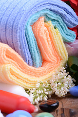 Image showing Spa still life with aromatic candles, stones, flower and towel, close up