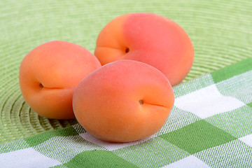 Image showing Full peaches close up on green material background.