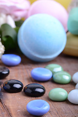 Image showing Beautiful spa setting with stone set, soap and sea salt on wooden table close up
