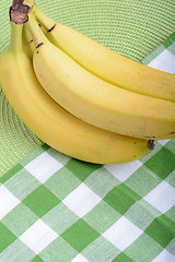 Image showing Bunch of ripe bananason green material background