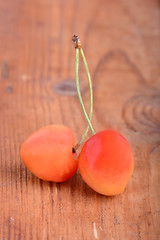 Image showing wooden plate with dark red juicy cherries close up