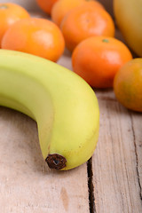 Image showing Fresh colorful fruits composition mandarin, bananas and orange