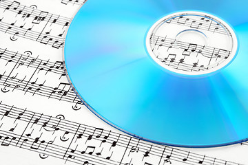 Image showing Blue CD or DVD on sheet music