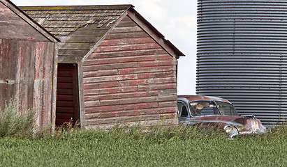 Image showing Wooden Granary and old car