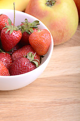 Image showing Close-up shot of variety of fruits on old wooden plate