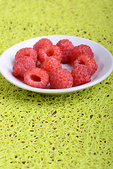 Image showing fresh raspberries on the white plate