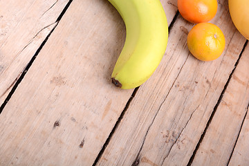 Image showing Fresh colorful fruits composition mandarin, bananas and orange