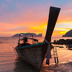 Image showing Traditional wooden longtail boat on beach in sunset, Thailand.