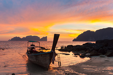 Image showing Traditional wooden longtail boat on beach in sunset, Thailand.