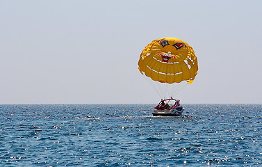 Image showing Parasailing in a blue sky