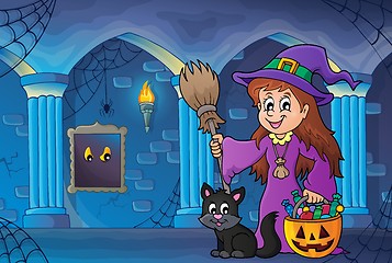 Image showing Cute witch and cat in haunted castle