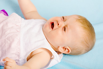 Image showing Crying baby lying on plaid