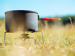 Image showing Can on portable camping stove