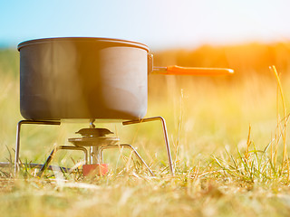 Image showing Can on portable camping stove