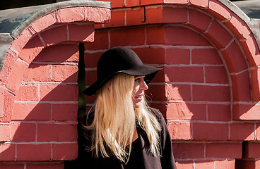 Image showing Blonde in black in old town