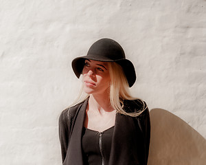 Image showing Blonde in black in old town