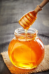 Image showing honey pouring into jar
